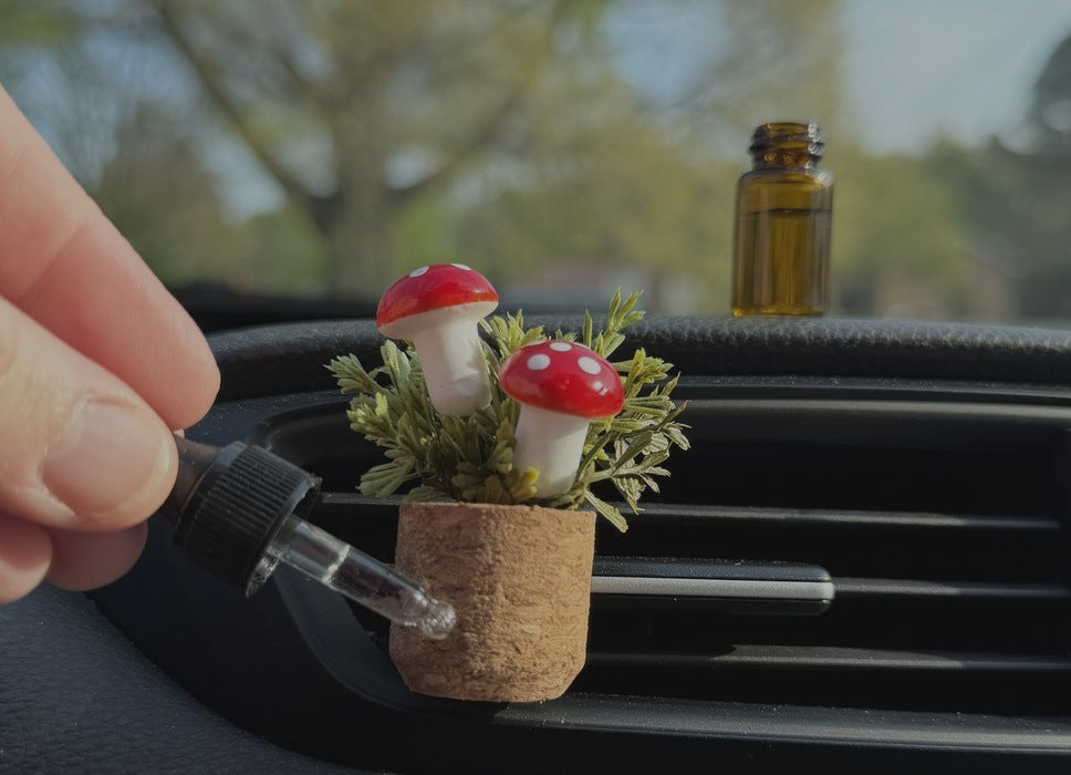 Fragrance oil refill being added to a mushroom plant vent clip diffuser